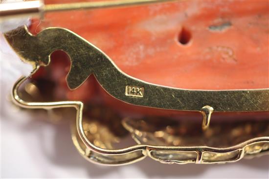 A Chinese 14ct gold mounted carved coral brooch, modelled as a masted ship at sea, 2.25in.